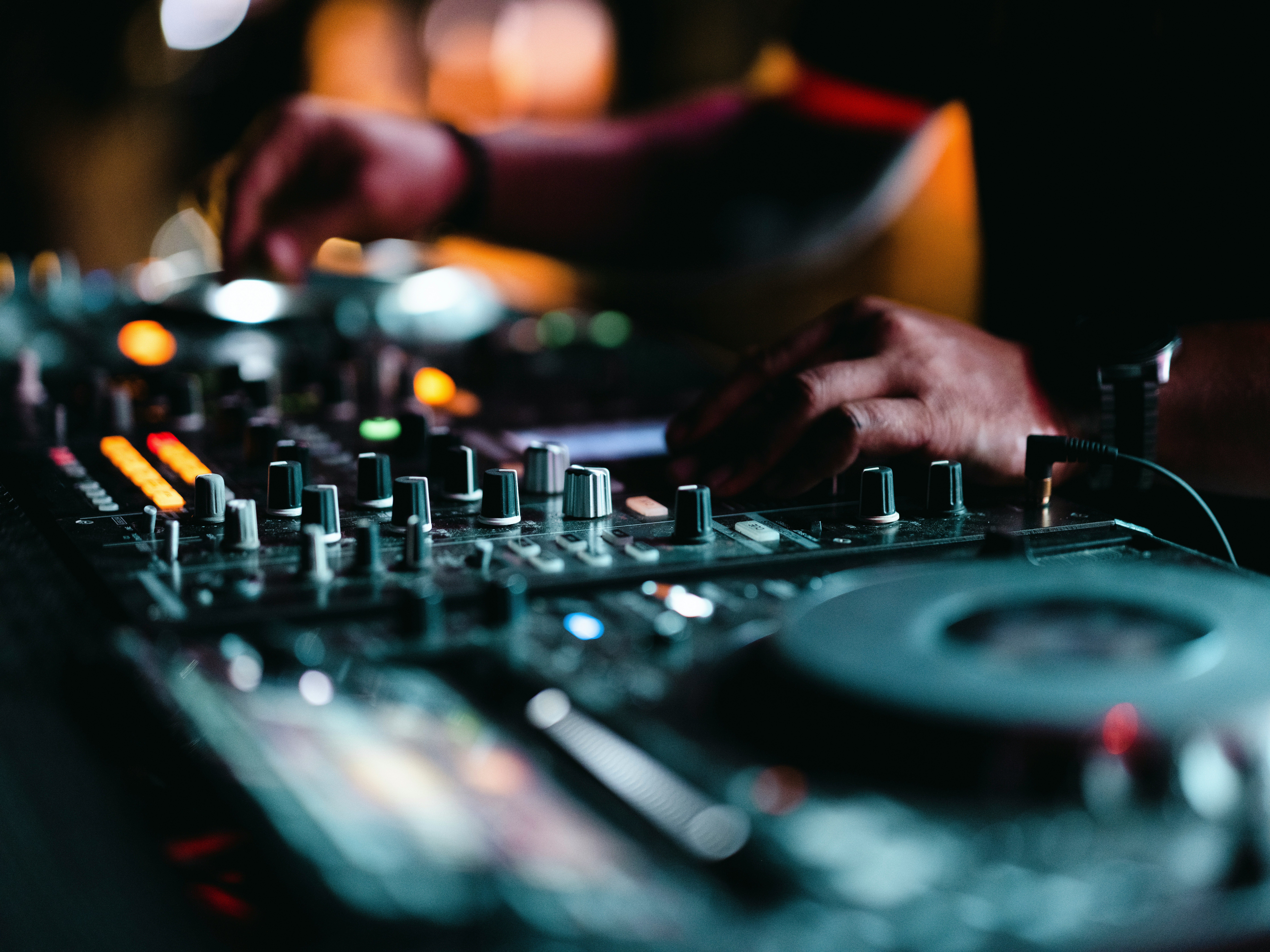 DJ Siyfion performing with professional equipment and vibrant lighting