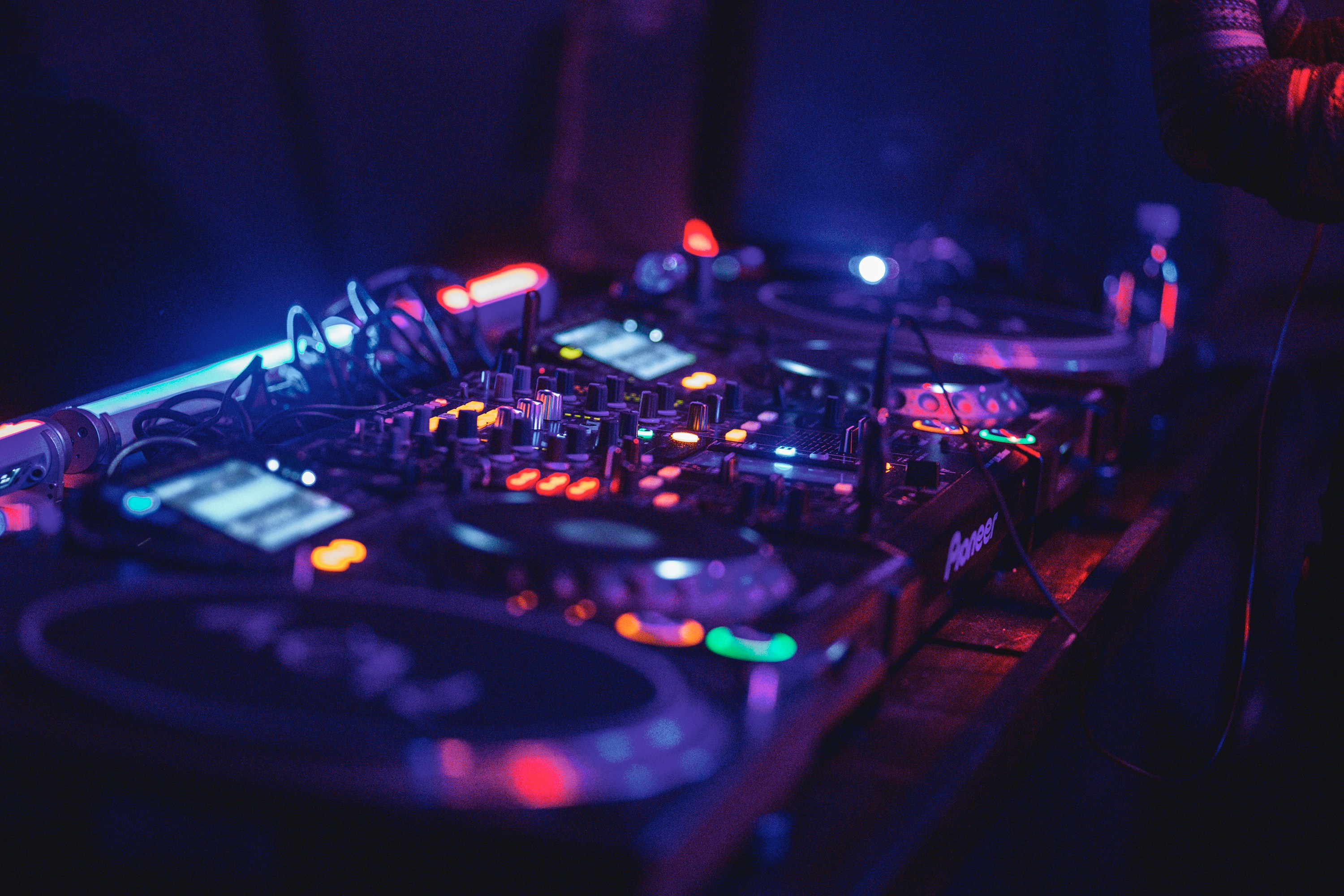 Professional DJ mixing console with colorful lighting effects